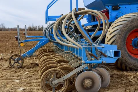 Precision seeder on a large tractor. Sowing of grain crops by means of a seed Stock Photos