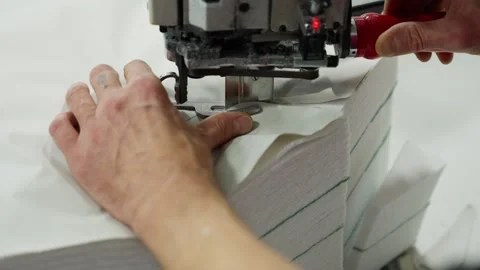 Precision Sewing Machine Operation in Workshop. Worker guides fabric through Stock Footage 271152999
