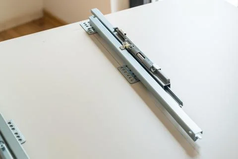 Precision sliding mechanism assembly attached to cabinetry in modern interior Foto stock
