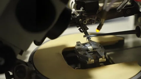 Precision station examining a semiconductor microchip under microscope Stock Footage 325976758