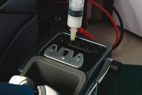 Precision task in a modern laboratory showcasing meticulous equipment setup Stock Photos