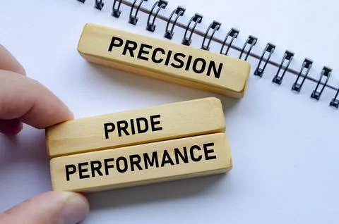 Precision through performance shown on wooden blocks over a notepad signifies Stock Photos