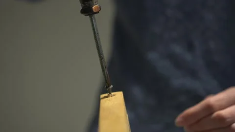 Precision Tool in Action Expertly Crafting with a Reliable Screwdriver for Stock Footage 318543964