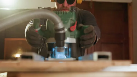 Precision woodworking close up of power tool operation with protective gear in Vídeo Stock 347103685