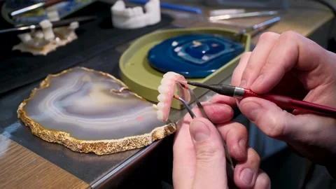 Precision work in dental aesthetics and prosthetic modeling. Stock Footage 311513982