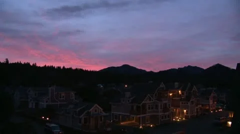 Predawn blue/pink sky tilt down night beach houses Stock Footage 10681813