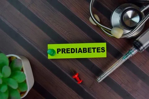 Prediabetes write on sticky notes isolated on Wooden Table. Stock Photos