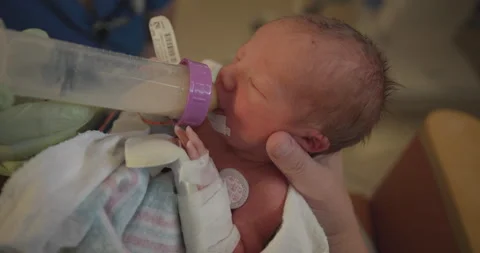Preemie Babys First Time Eating from a Bottle Stock Footage 254051317