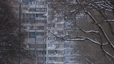 Prefabricated block of flats and bare trees on winter day Stock Footage 154118097