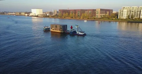 Prefabricated floating house under tow across the IJ Stock-Footage 71296560