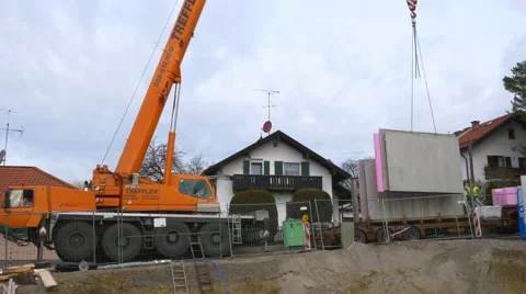 Prefabricated house, workers in setting up the basement walls Stock Footage 62023359
