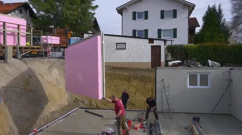 Prefabricated house, workers in setting up the basement walls Stock Footage 62042005