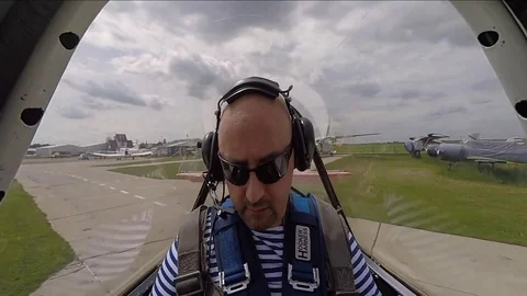 Preflight preparation, belt fastening, headphone adjustment in small Yakovlev 5 Stock Footage