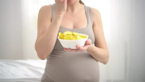 Pregnancy cravings with chips Stock Footage 308017350
