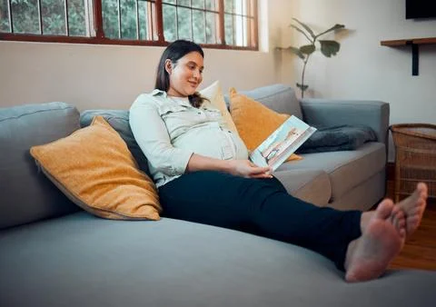 Pregnancy, reading and woman with a book on the sofa for her baby, relax and Stock Photos