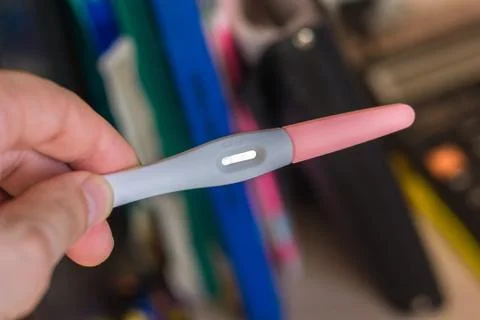 Pregnancy test in a human hand. Stock Photos