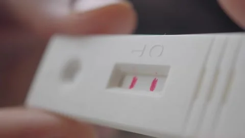 Pregnancy test shows two lines indicating a positive result Stock Footage 335119276