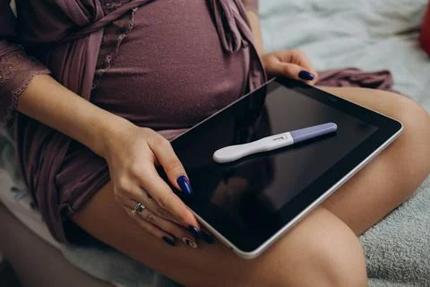 The pregnancy test is on the tablet Stock Photos