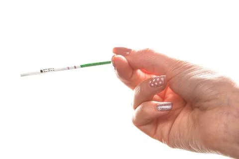 A pregnancy test with two strips in the hands of a young woman. on a white is Stock Photos