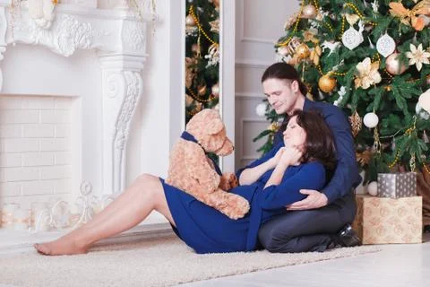 Pregnancy young couple on sofa Stock Photos