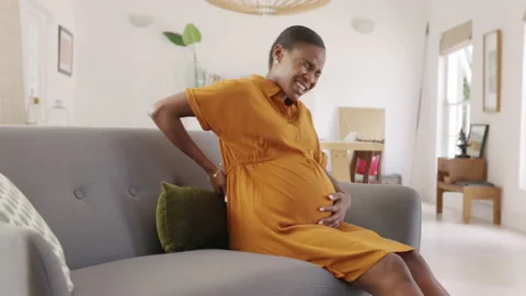Pregnant african american woman having backache during gestation Stock Footage