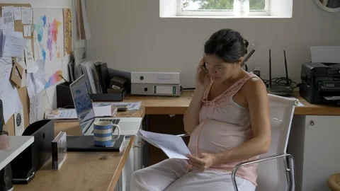 Pregnant Asian-american woman working from a home office Stock Footage
