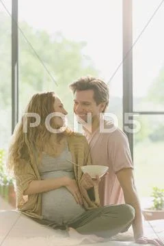 Pregnant couple eating and talking Stock Photos