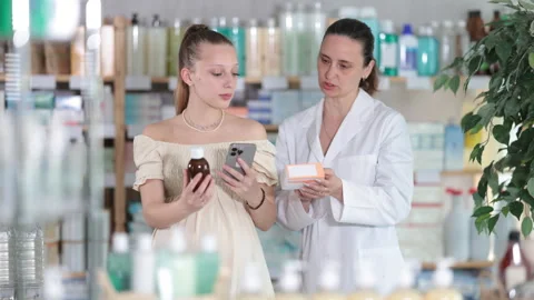 Pregnant girl scans code on package of cough syrup to check expiration date Stock Footage 314763673