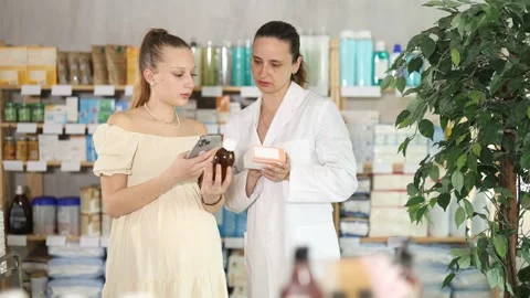 Pregnant girl scans code on package of cough syrup to check expiration date Stock Footage 326315580