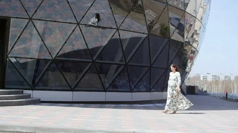 Pregnant girl walking, slowmotion Stock Footage