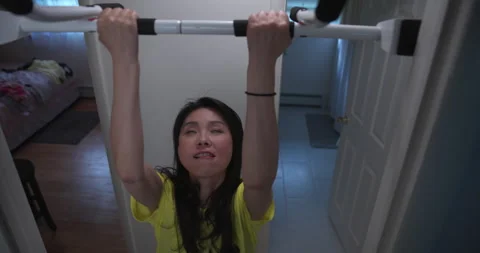 Pregnant Lady Struggles to do a Pullup Stock Footage 174751936