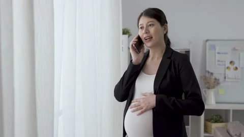 Pregnant manager standing by the window Video stock 145179526
