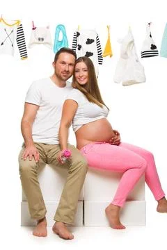 Pregnant woman and her husband Pregnant woman and her husband isolated on ... Stock Photos