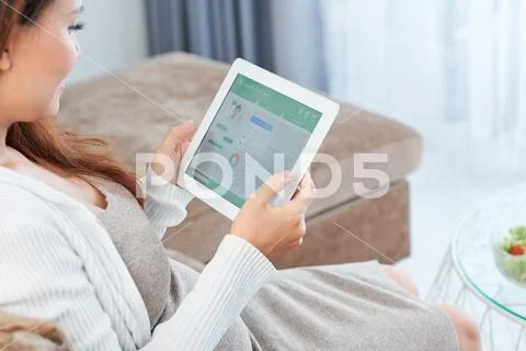 Pregnant woman chatting with physician Stock Photos