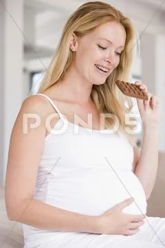 Pregnant woman with chocolate smiling Stock Photos