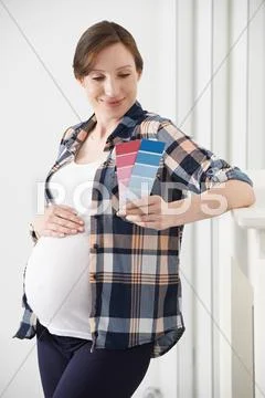 Pregnant Woman Choosing Color Scheme Fort Baby's Room Stock Photos