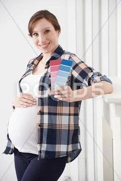 Pregnant Woman Choosing Color Scheme Fort Baby's Room Stock Photos