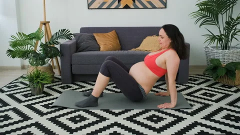 Pregnant Woman Doing Shoulder Bridge Exercise Stock Footage
