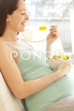 Pregnant Woman Eating A Fruit Salad
