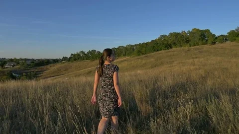 Pregnant woman in field at sunset Stock Footage
