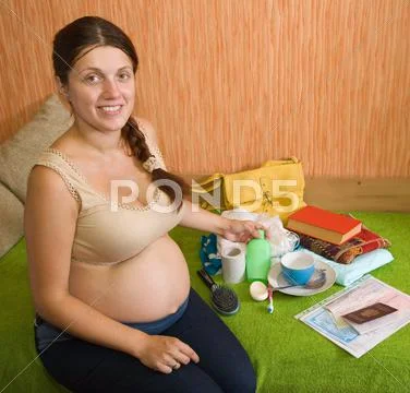 Pregnant woman get ready for maternity clinic Stock Photos