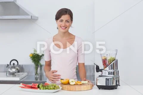 Pregnant woman making a fruit cocktail Stock-Fotos