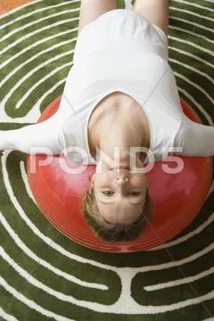 Pregnant woman stretching on a fitness ball Stock Photos