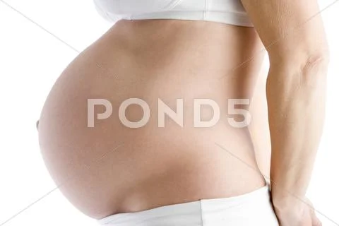 Pregnant woman's exposed belly Stock-Fotos
