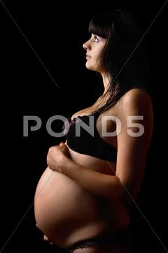Pregnant young woman in lingerie. Isolated Stock Photos