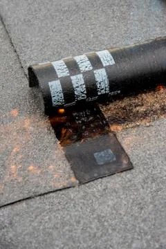Preheating the edges of the roofing material. Stock Photos