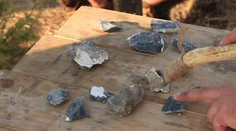 Prehistoric Man is Using Iron Tool for Sharpening Stones Stock Footage 60605397