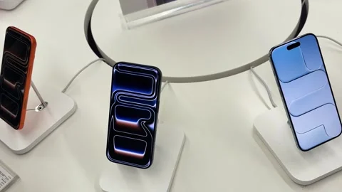 Premium apple Smartphones Showcased on Interactive Display Counter in apple Stock Footage 340957642