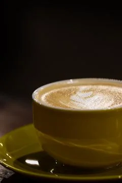 Premium Caffe Latte with Heart Pattern Art in Yellow Ceramic Cup, Creamy Es.. Stock Photos