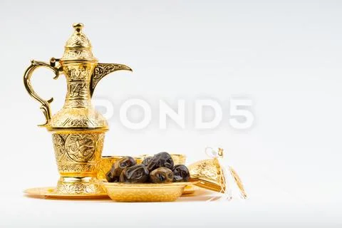 Premium dates and arabic coffee set on white background. Stock Photos